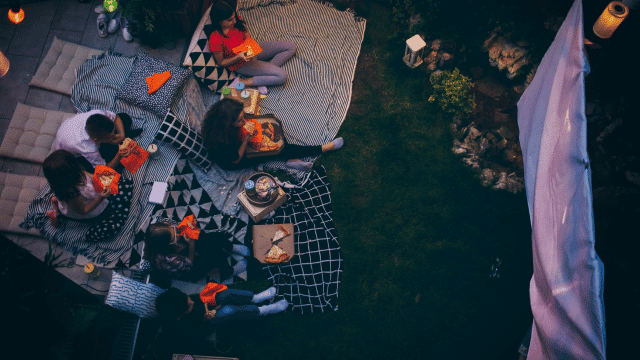 A family having a backyard movie.