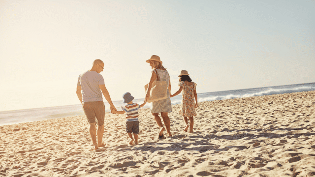 Family enjoying a fun summer activity at the beach.